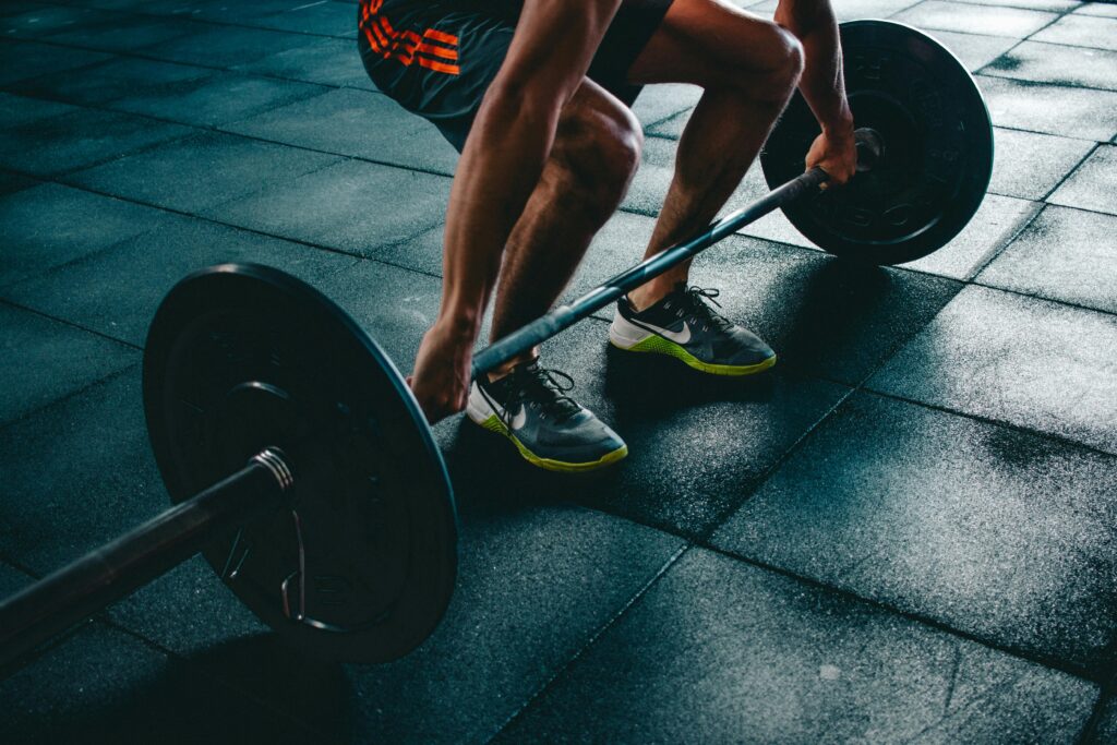 a man lifting weights in a gym, began to focus on personal growth